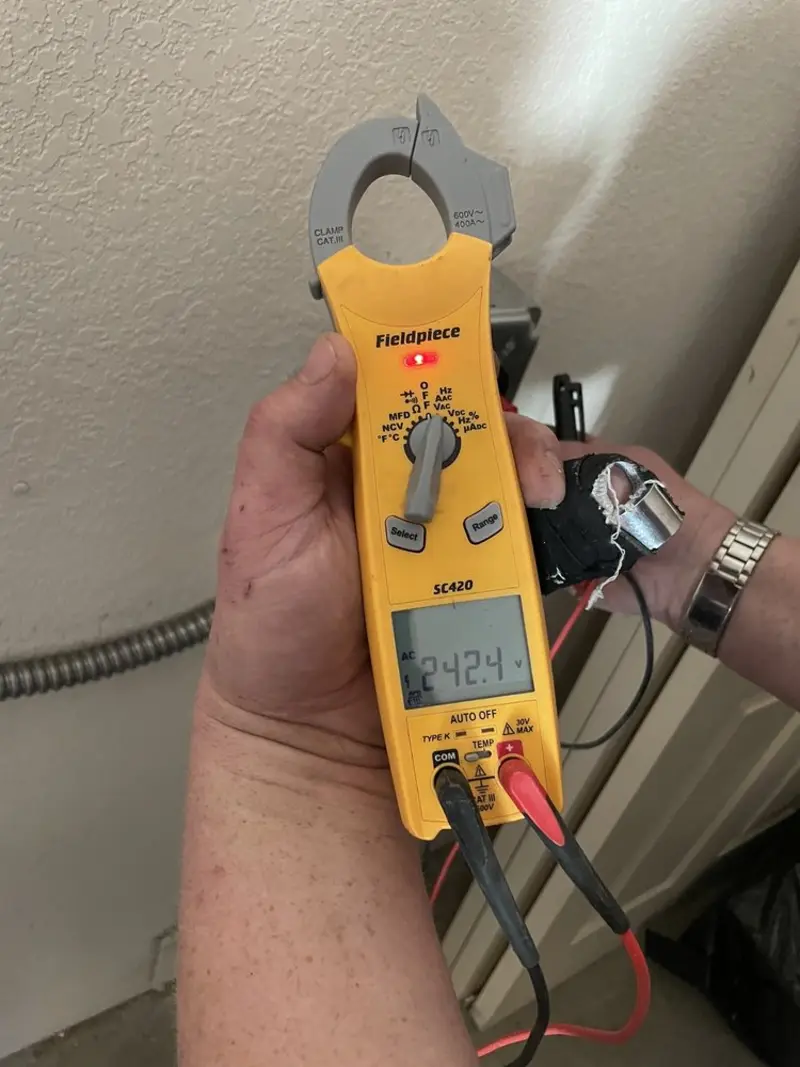 Voltage testing with clamp meter during Electrical Installation Services in Greenville